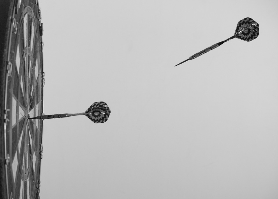 A dart flying towards a dartboard